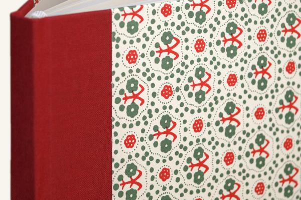 Hard cover notebook with green and red pattern, red linen spine